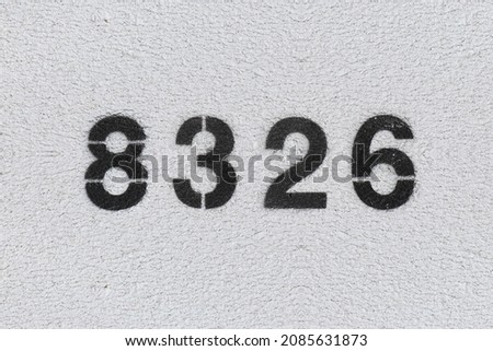 Black Number 8326 on the white wall. Spray paint. Number eight thousand three hundred and twenty six.