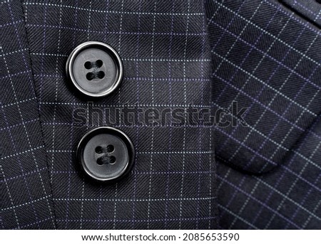 Sleeve with buttons on the men's check suit. Men's suit. Part, item of clothing Royalty-Free Stock Photo #2085653590