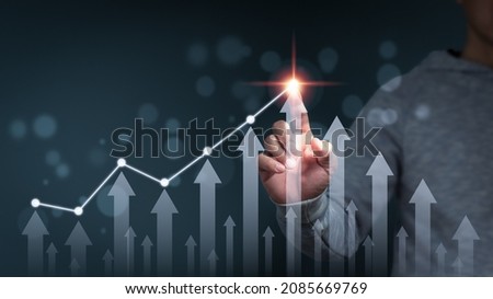 A businessman shows an arrow graph that depicts the company's future growth strategy and percentage increase. The idea is to start a business from the ground up in order to succeed and grow. Royalty-Free Stock Photo #2085669769