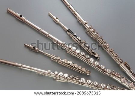 Large and small flutes are spread out on a gray surface  Royalty-Free Stock Photo #2085673315