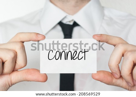 Connect. Businessman in white shirt with a black tie showing or holding business card 