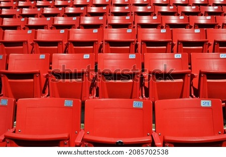 repetition of empty red seats of a football stadium horizantal picture 