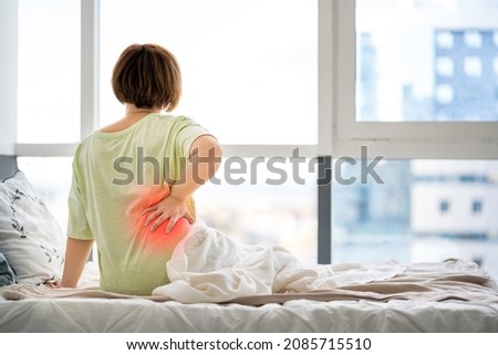 Back pain, kidney inflammation, woman suffering from backache at home, health problems concept Royalty-Free Stock Photo #2085715510