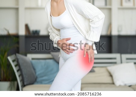 Hip pain, woman suffering from osteoarthritis at home, health problems concept Royalty-Free Stock Photo #2085716236
