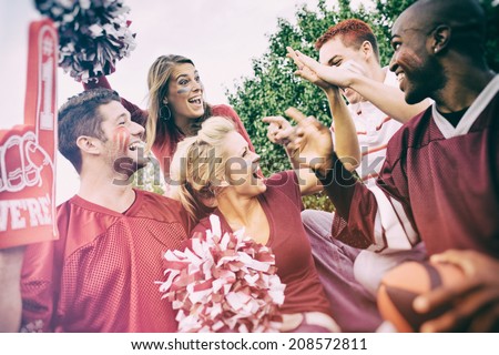 Tailgating: College Student Fans Give High Five For Team Win Royalty-Free Stock Photo #208572811