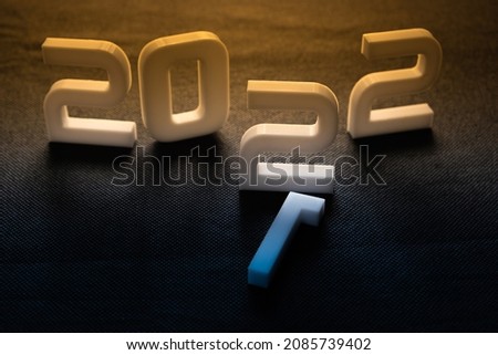 White 3D numbers on a dark blue and gold background.