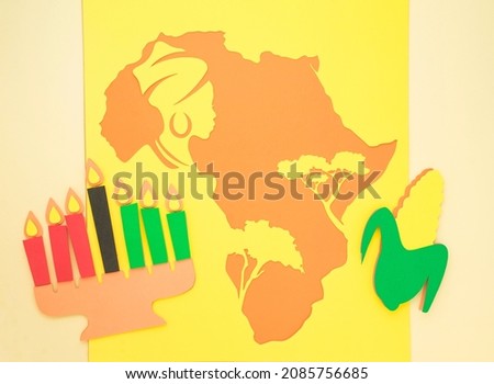 Happy Kwanzaa Greeting Card Background. Candleholder made from paper leaves. Paper art concept