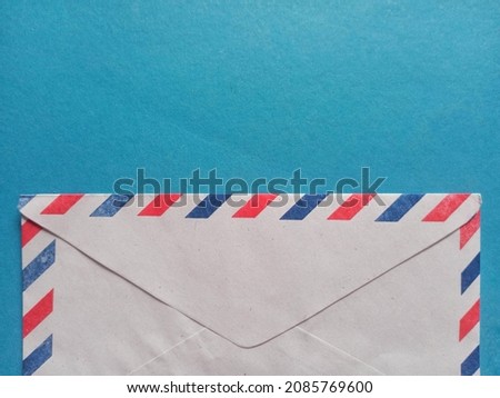 envelope with red blue stripes on a light blue background