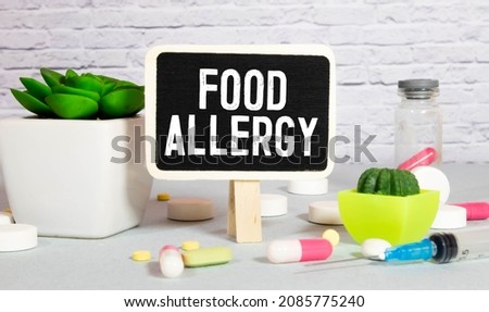 Wooden blocks with text Food Allergy with stethoscope. Medical concept.