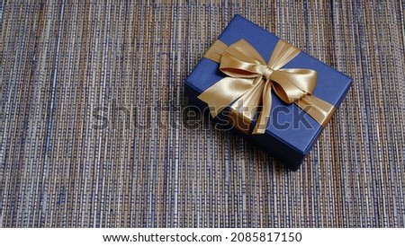 Cute gift box with satin ribbon on the table. Christmas and new year concept, Valentine Concept. Copy space, Negative Space. 