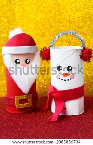 Handmade craft project from toilet tube. Creative kids DIY New year. Cute Snowman and Santa Claus for Christmas party. Vertical picture