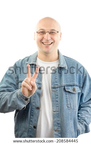 fat bald man wearing jeans jacket makes victory sign 