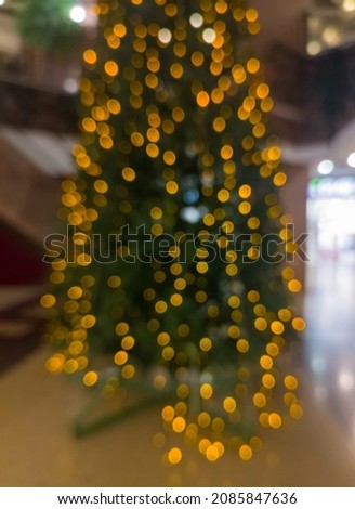 Out of focus blurred bokeh, christmas tree in the supermarket.
