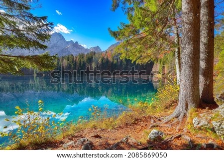 Fairytale view of Fusine lake with Mangart peak on background. Popular travel destination of Julian Alps. Location: Tarvisio comune , Province of Udine, Italy, Europe