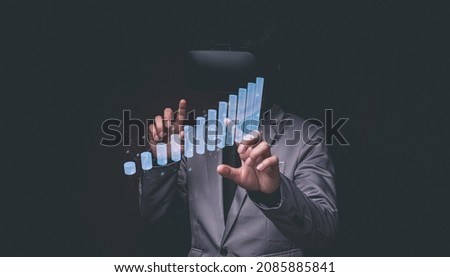 Businessman using Virtual Reality Metaverse glasses to virtual world showing bar graph business growth