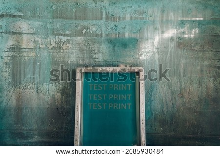 Screen printing film in workshop standing against the green background