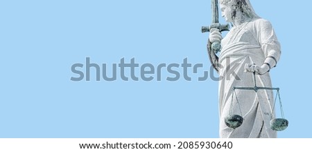 Banner with ancient statue of goddess Justice with sword, scale as decoration at top of Doge Palace in Venice, Italy, at blue sky background with copy space. Concept of cultural historical heritage