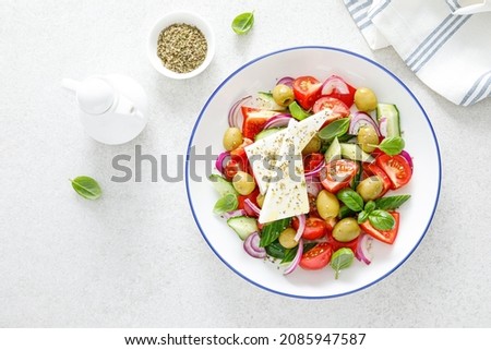 Greek or horiatiki salad with fresh vegetables and feta cheese, dressed with olive oil, traditional Greek cuisine salad Royalty-Free Stock Photo #2085947587