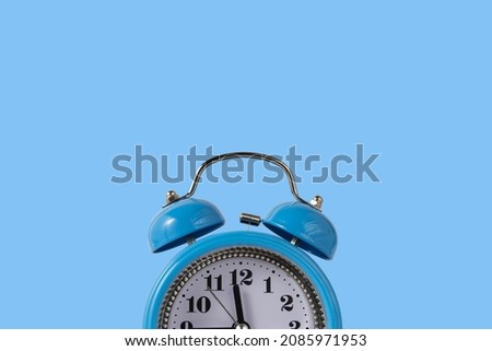 Alarm clock over blue. Time concept. Blue alarm clock morning time. Blue alarm clock blue copy space.