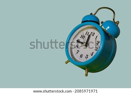 Full frame of alarm clocks on blue background
Blue alarm clock. Blue alarm clock on a light blue background.
Flying alarm clock.
