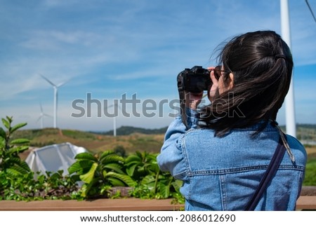 Portrait of Woman Taking Photos of Wind Power Plant