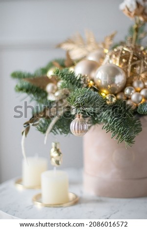 Beautiful winter Christmas floral composition of fresh Nobilis in hat box. Cotton, spruce, sparkling ornaments. Holiday concept. Happy New Year decorations.