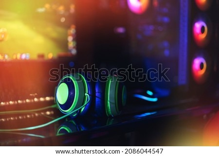 Gaming computer peripherals under neon light.