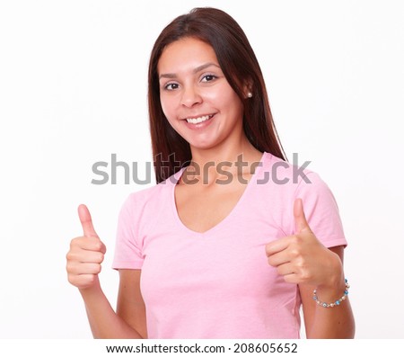 Portrait of 20-24 years young woman on pink t-shirt with ok gesture smiling and looking at you on isolated studio