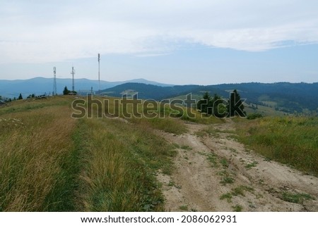Dirt road and cell towers in beautiful Carpathian Mountains in Ukraine