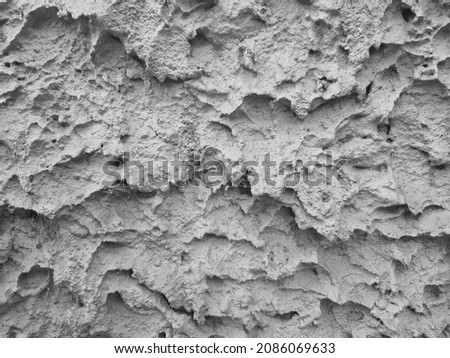 Background texture: ancient decorative abstract gray chalk coating of house wall. Cement pattern of street facade, lime covering of cottage cladding