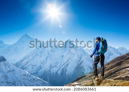 Hiker enjoying the view on the Everest trek in Himalayas, Ama Dablam mountain view, Nepal Royalty-Free Stock Photo #2086083661