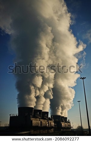 Factory chimneys with smoke emission. Industrial factory pollution, smokestack exhaust gases. factory chimney Royalty-Free Stock Photo #2086092277