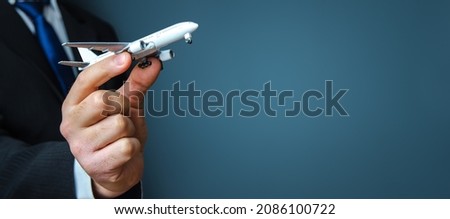 Businessman holding a airplane. Organization of flight traffic. Business and transport, air communication. Infrastructure for business development. Airline loyalty program. Tourism and travel. Royalty-Free Stock Photo #2086100722
