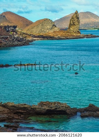 View of an underwater crater in the foreground with Pinnacle Rock in the background on Bartolome Island in the Galapagos Islands
