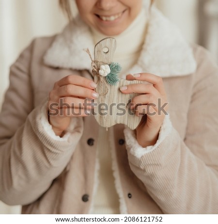Young stylish girl in warm clothes with Christmas decoration. New year model laughing, showing joy and emotions