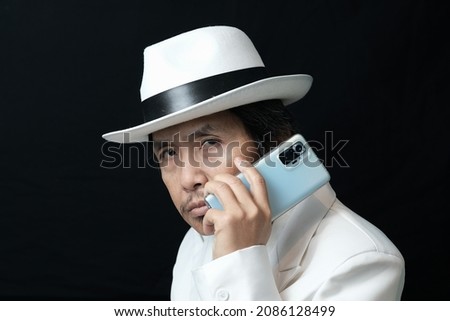 Close-up portrait of a man using phone