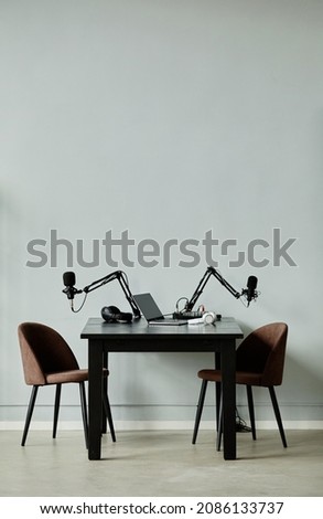 Vertical background image of podcast recording studio with two chairs, copy space