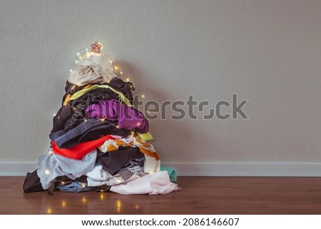 A pile of clothes in the shape of a Christmas tree
