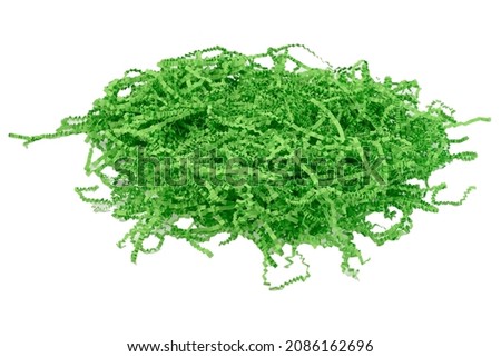 green confetti shredded crinkled paper for gifts and stuffing in cardboard boxes.Isolated white background Royalty-Free Stock Photo #2086162696