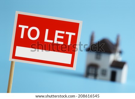 Real estate agent to let sign with house in background
