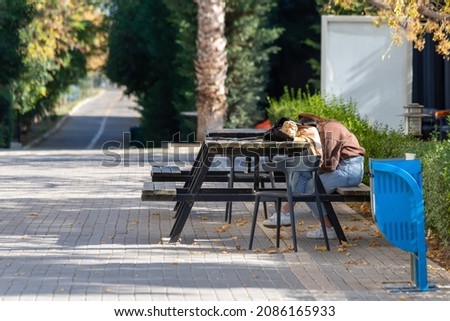 A student falling asleep in the schoolyard after class