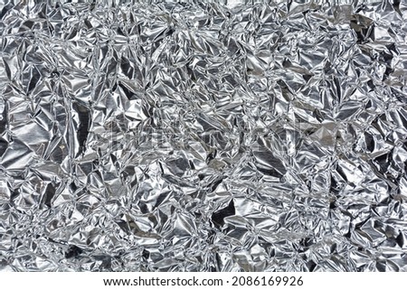 Silver foil with a shiny mint surface for the background. Silver color and texture background Royalty-Free Stock Photo #2086169926