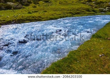 emerald river rushing  through mountain valley