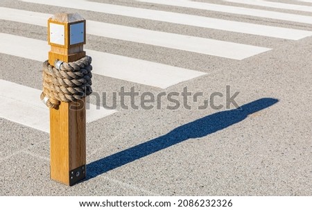 Zebra Crossing, Low Angle View, wooden bollard with traffic zebra. Street view, selective focus, nobody, copy space for text
