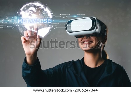 Women wearing VR goggles, Metaverse's global internet connection, Metaverse's digital cyberspace, and metaverse virtual reality experiences for the future of business. Creating a virtual reality Royalty-Free Stock Photo #2086247344