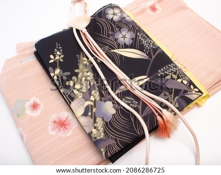 A Kimono set for everyday wear in Japan (kimono, obi, obi holder, obi string), Sakura pattern: Made from polyester, not silk. Royalty-Free Stock Photo #2086286725