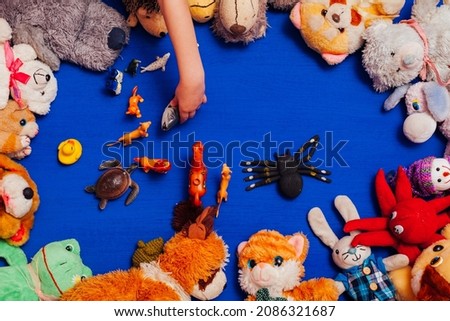 lots of children's soft animal toys on a blue background