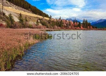 The Rocky Mountains of Canada. Indian summer in the Rocky Mountains. Evergreen huge forests in the Rocky Mountains. The cold water of Lake Vermillon 