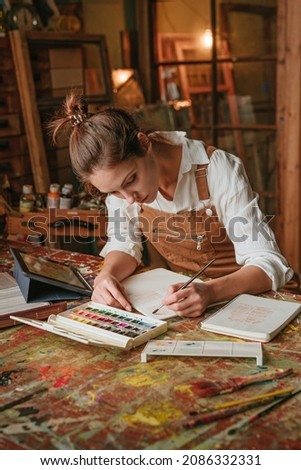 Young artist concentrating on drawing process at art studio