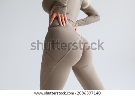 Fitness model in leggings with beautiful buttocks. Sporty booty Royalty-Free Stock Photo #2086397140